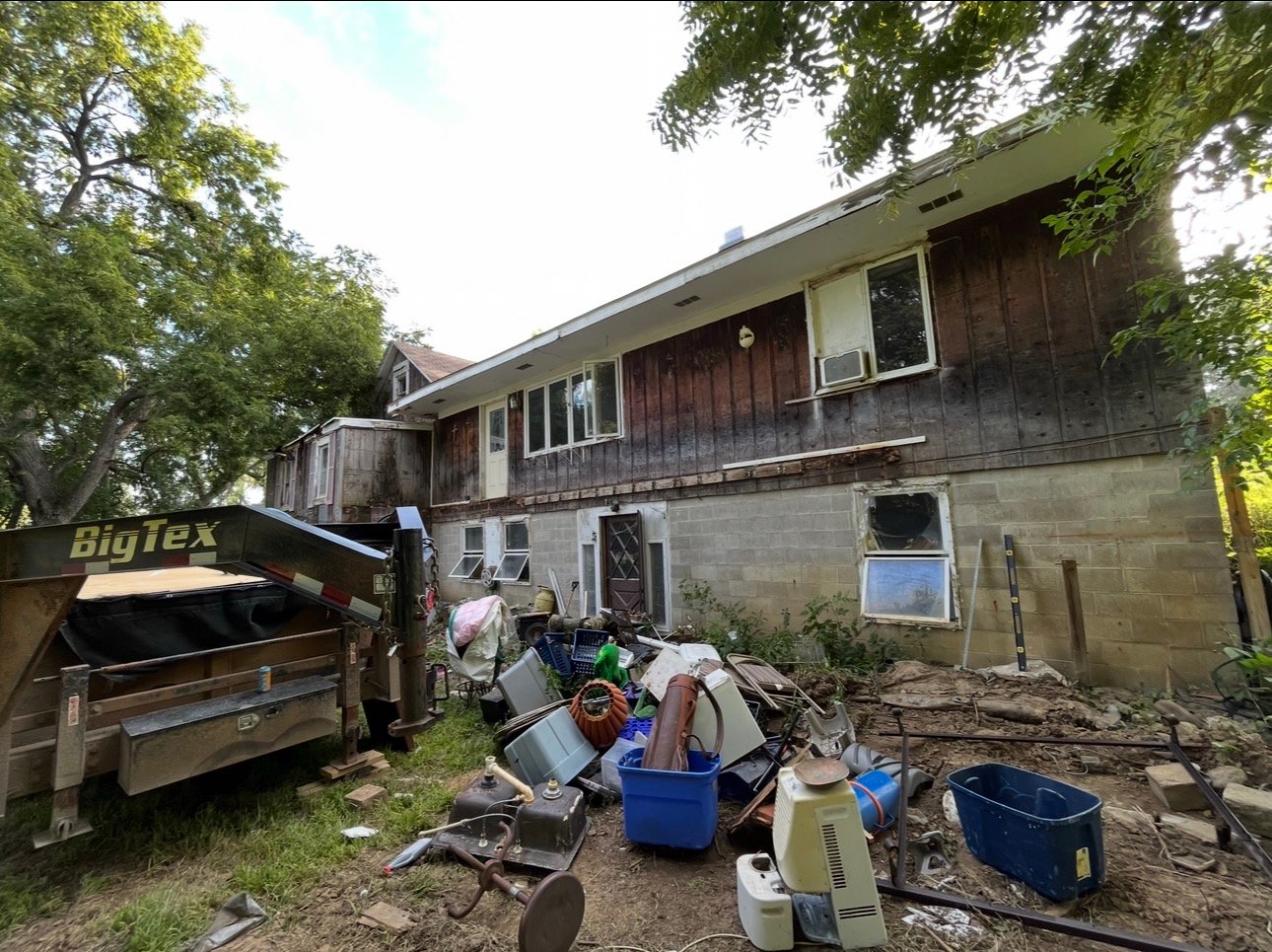 A distressed Siouxland house with a trailer during an as-is property project